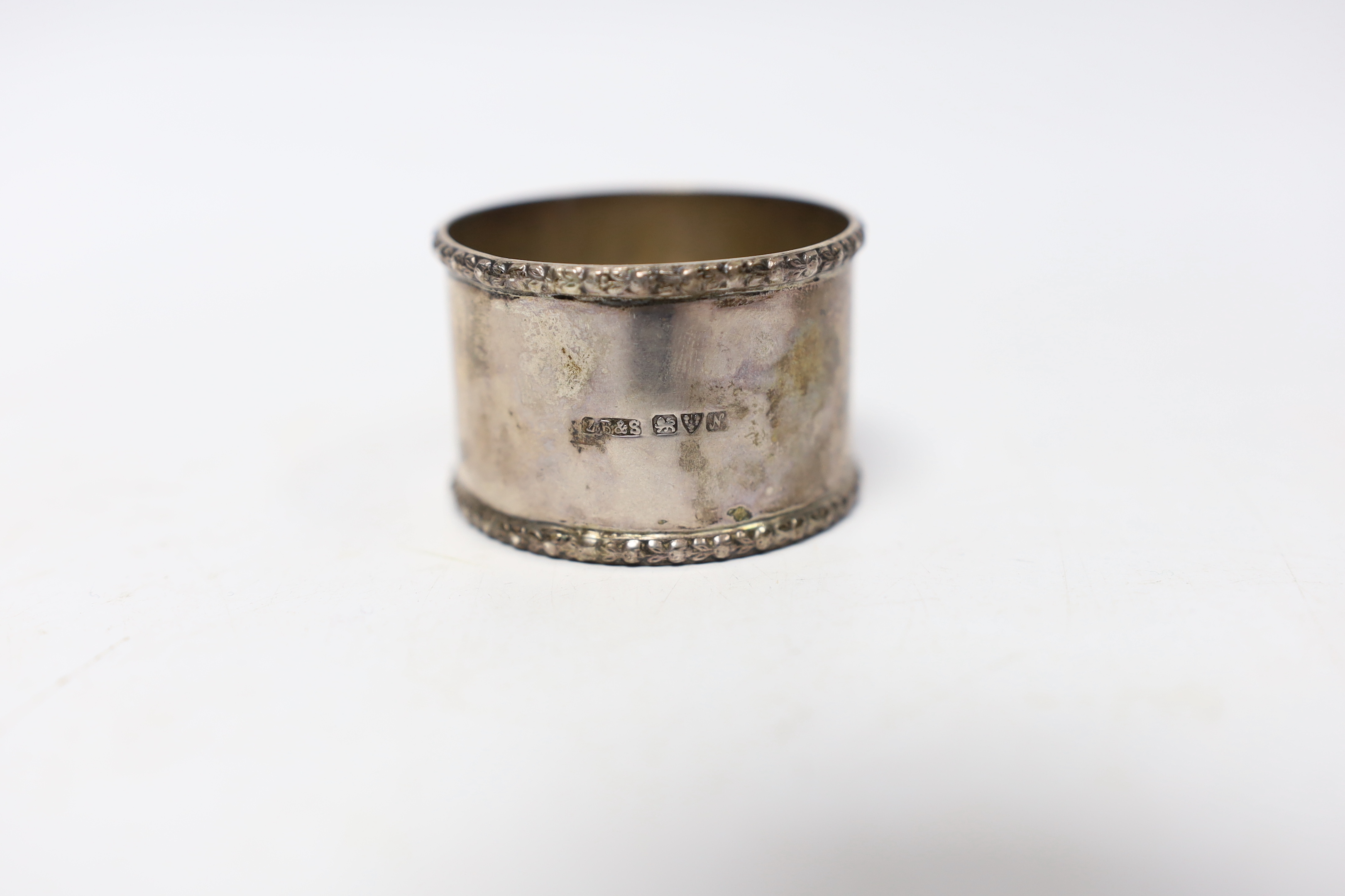 Seven assorted silver napkin rings and a small silver bowl